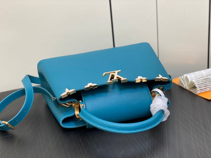CAPUCINES MM 31 BLUE TAURILLON GOLD HARDWARE