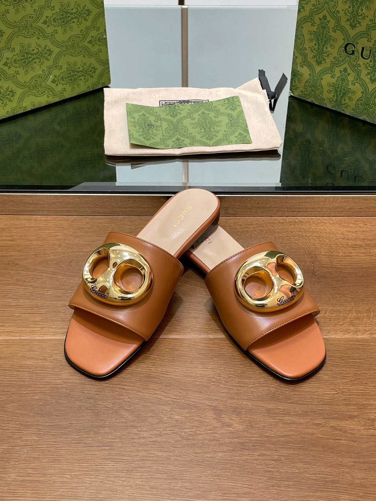 FLAT MULE IN BRONE BROWN CALFSKIN WITH GOLD HARDWARE