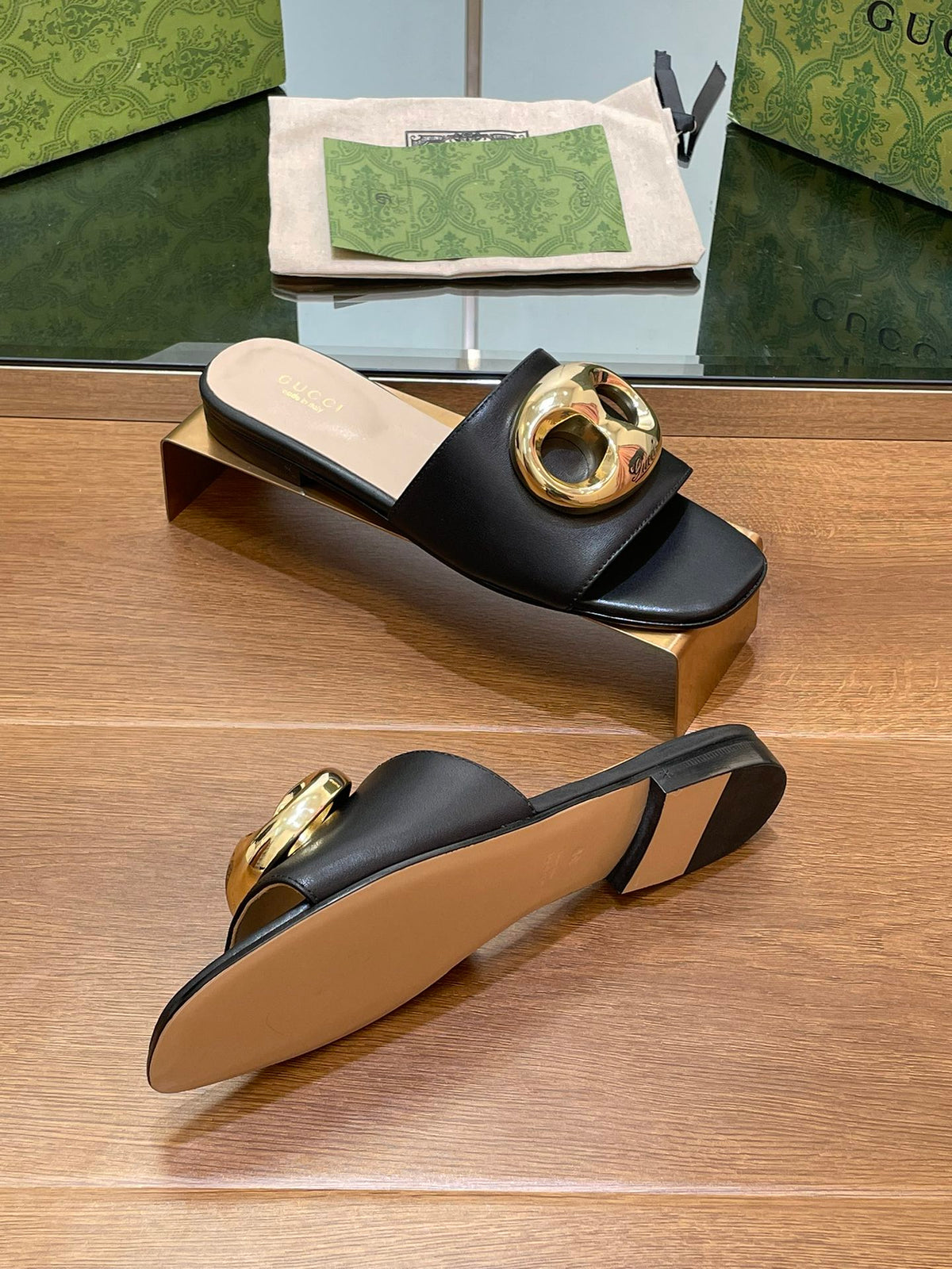 FLAT MULE IN BLACK CALFSKIN WITH GOLD HARDWARE