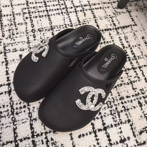 FLAT MULES IN BLACK CALFSKIN